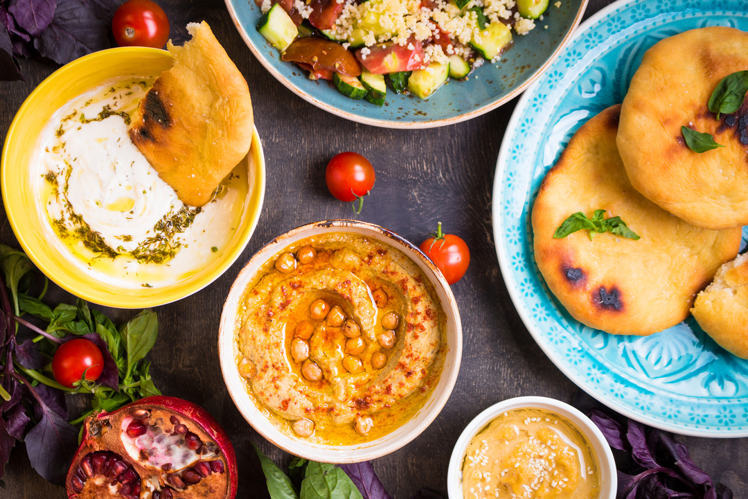 Table Served with Middle Eastern Vegetarian Dishes. Hummus, Tahi